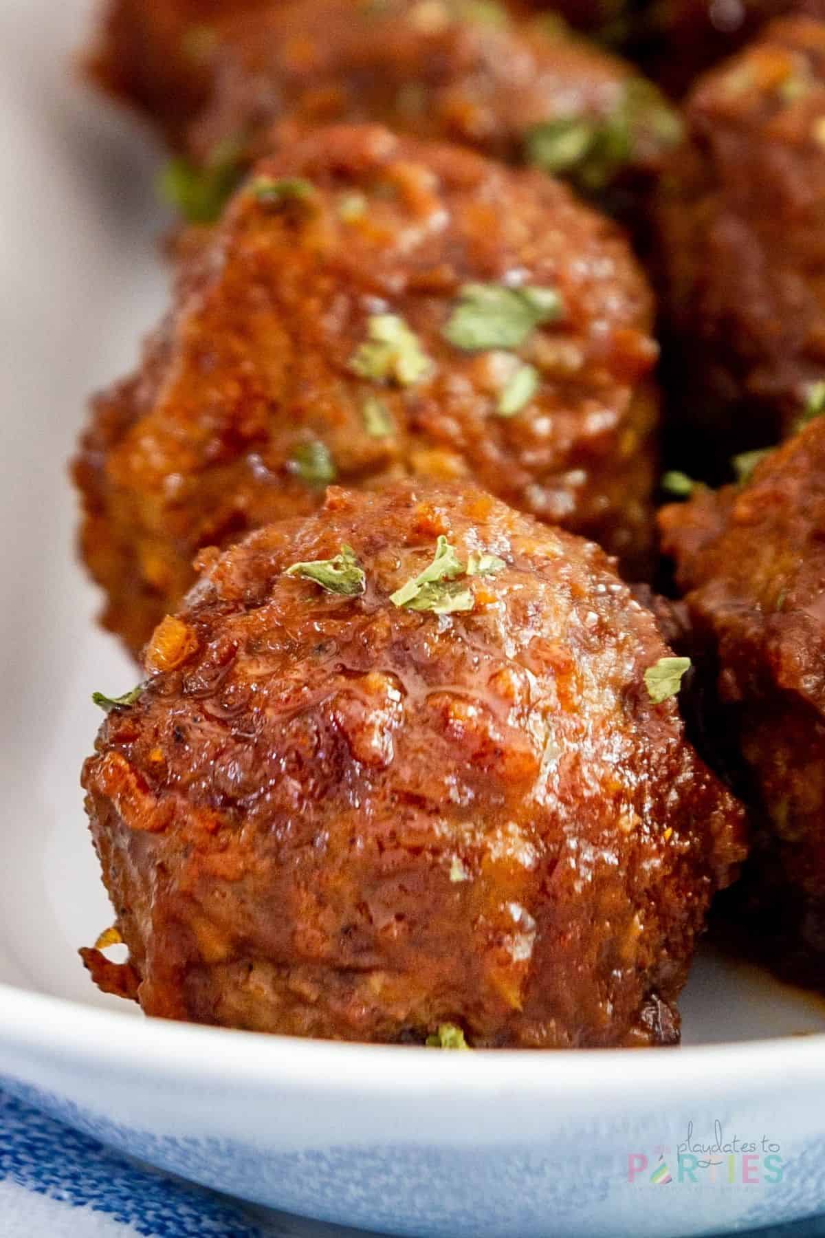 close up image of a meatball on a white plate