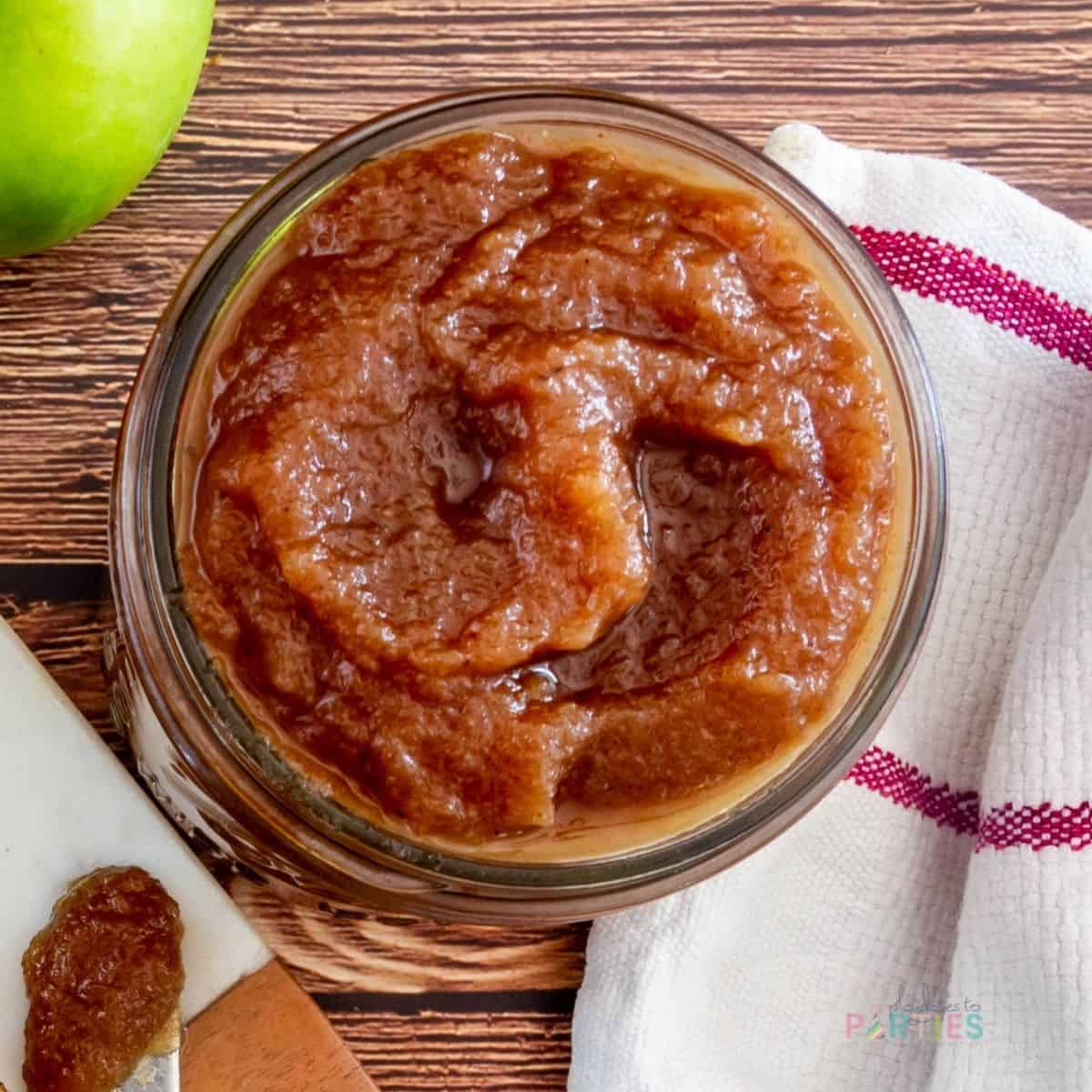 close up overhead view of of apple butter in a wide mouth canning jar