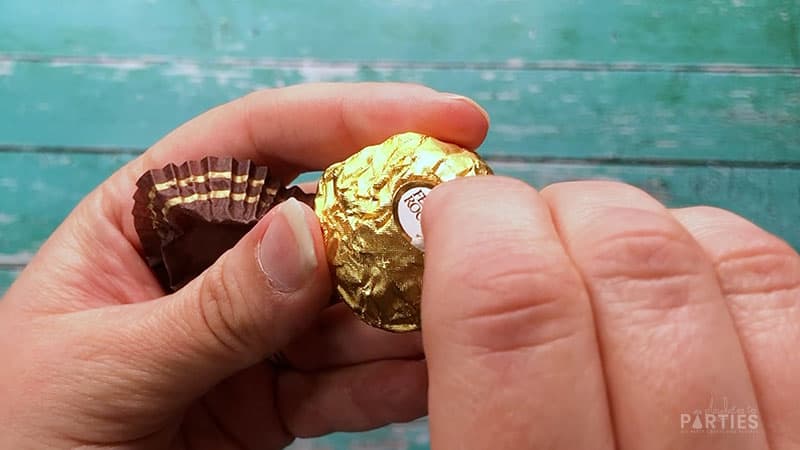 Remove stickers and brown wrapper from Ferrero Rocher truffles.