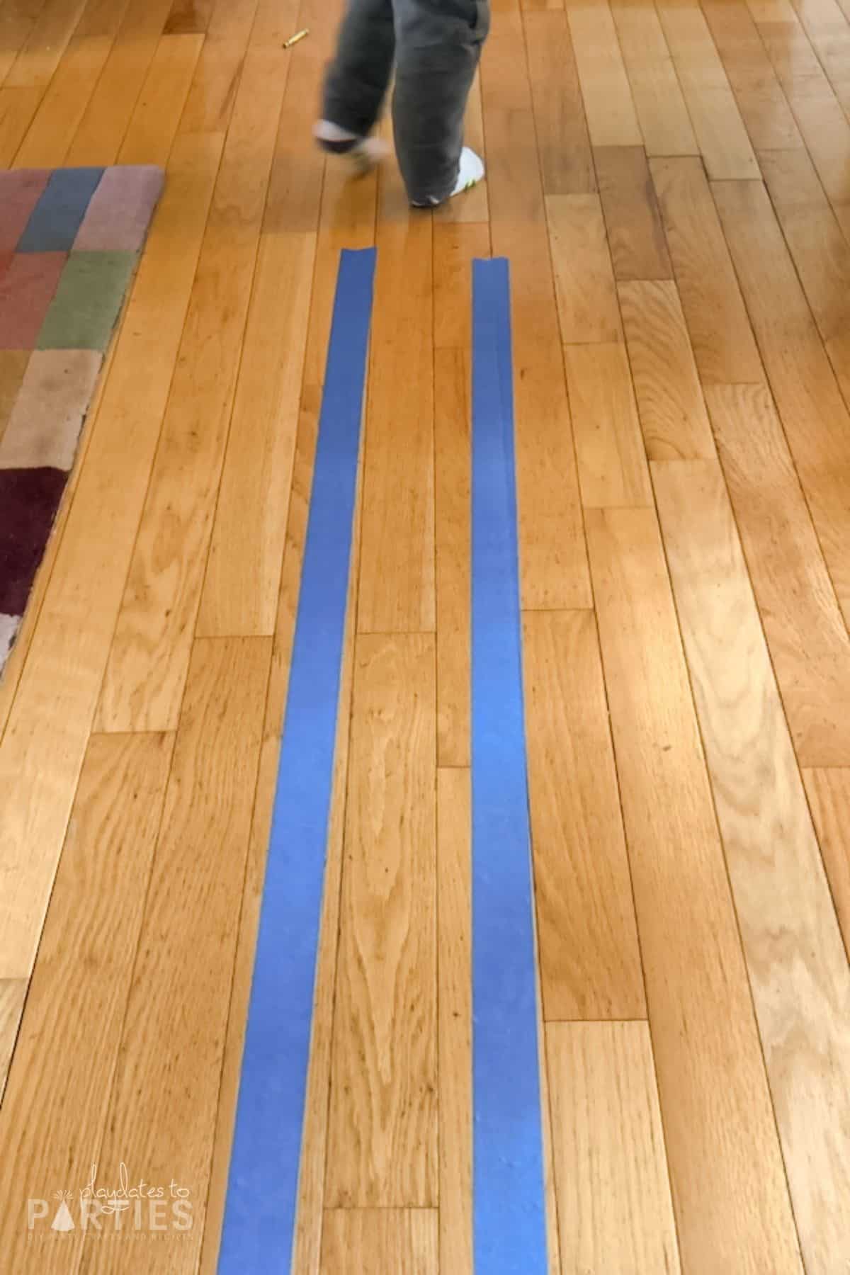 Painter's tape made in two parallel lines on a hardwood floor