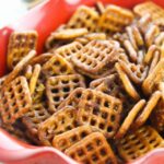 seasoned mini pretzels in a red bowl with a ruffled edge