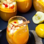 Wine glasses on a black table filled and ready for a party.