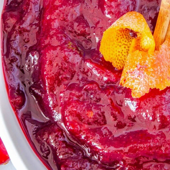 Close up overhead view of a bowl of sauce on a white counter.