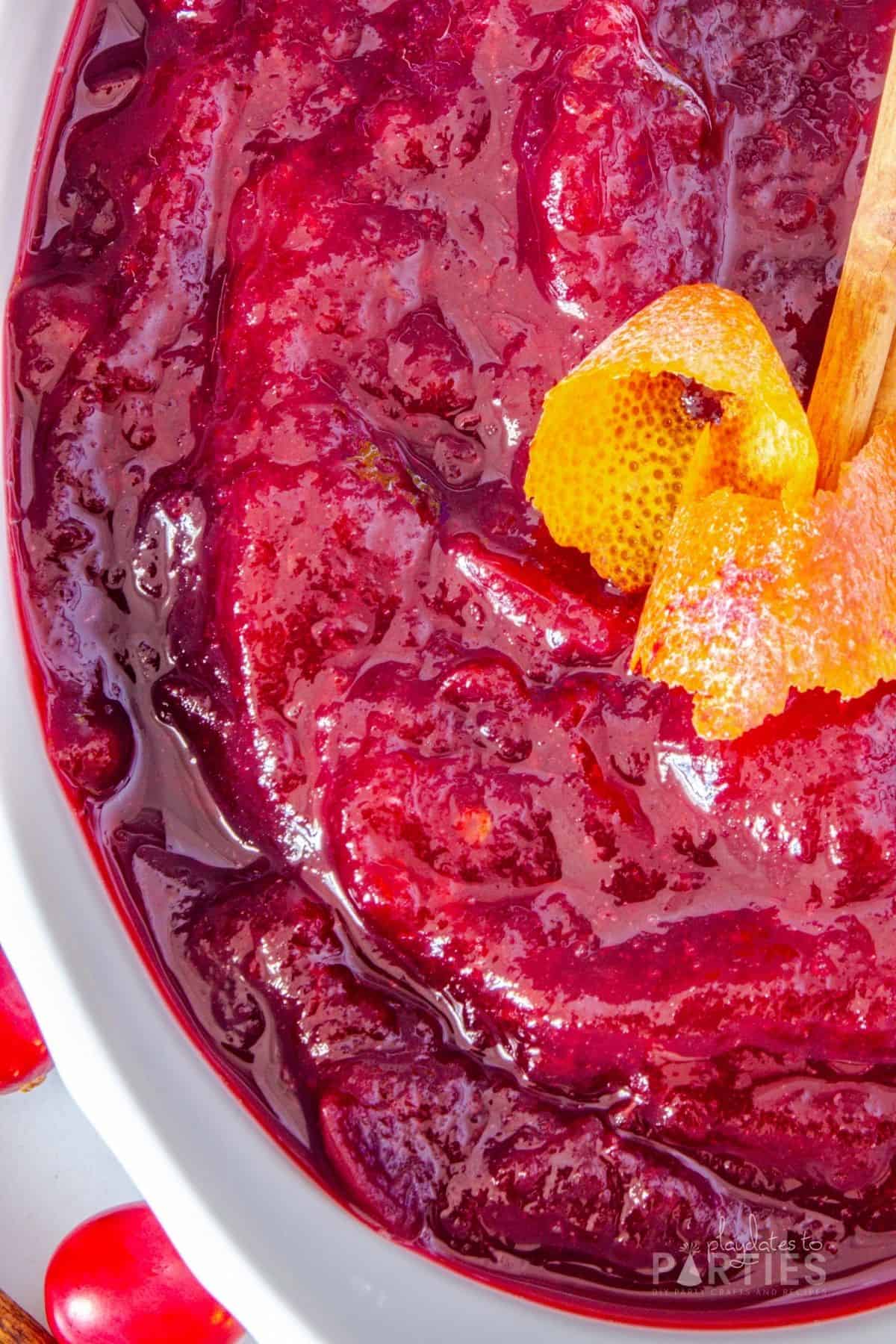 Close up overhead view of a bowl of sauce on a white counter.