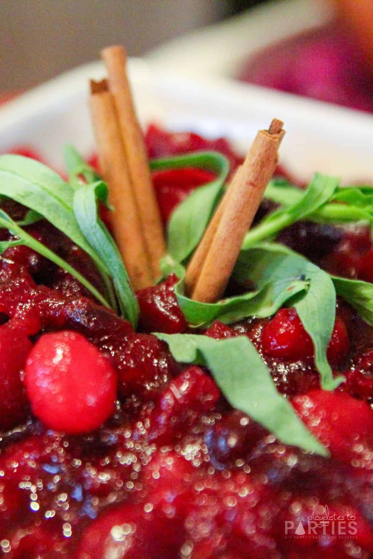 Close up of a garnish using sage and cinnamon stick.