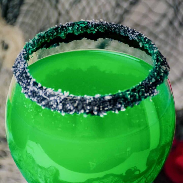 Green Halloween cocktail rimmed with black and white salt.