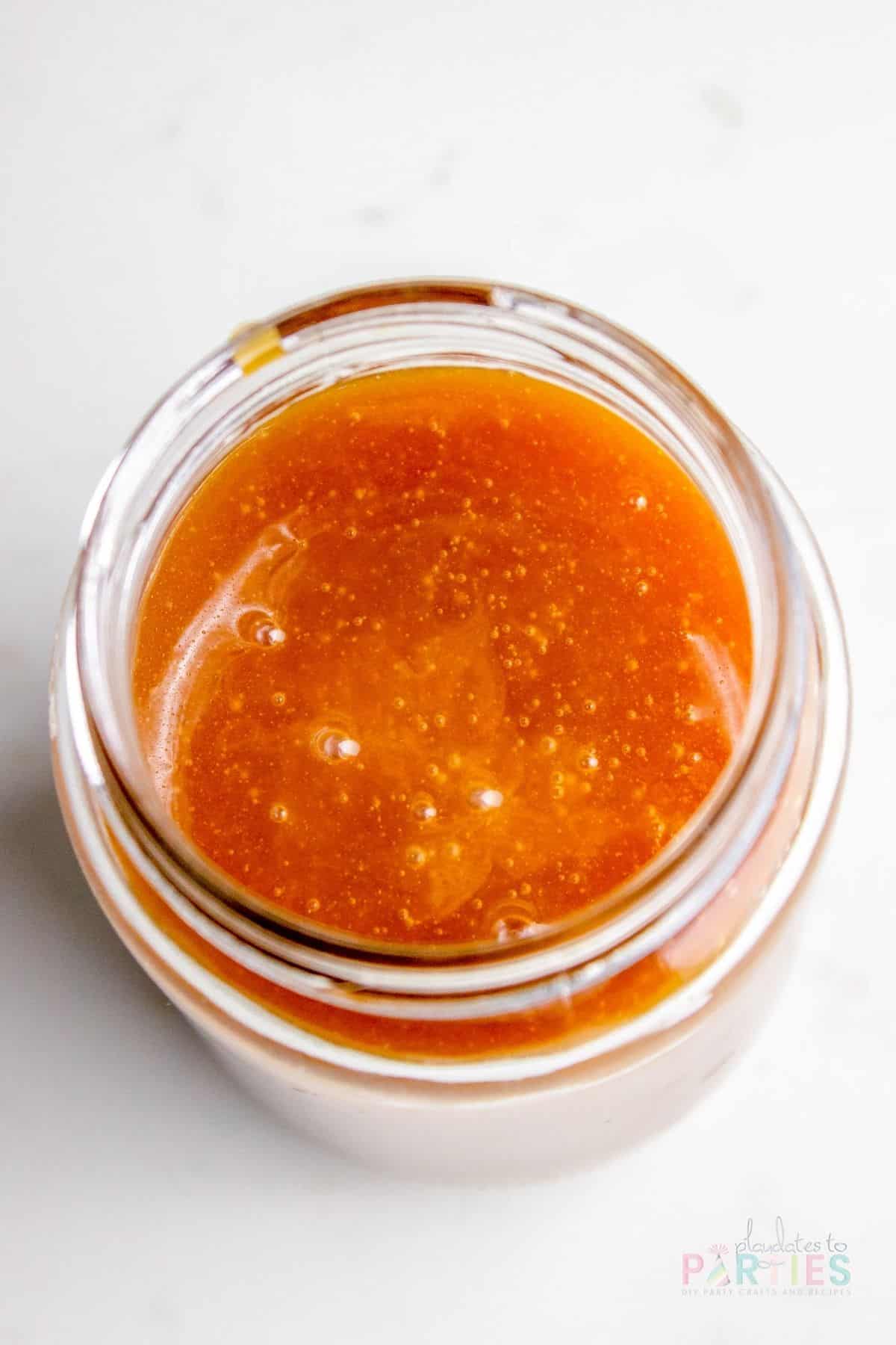 Close up overhead view of sauce freshly poured into a jar.
