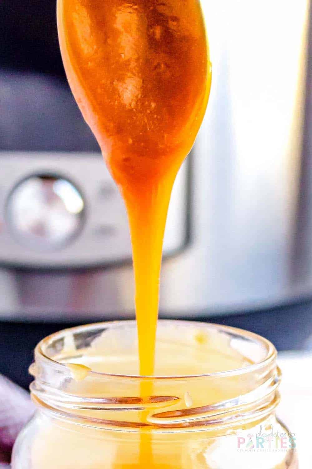 Close up of caramel dripping from a spoon.
