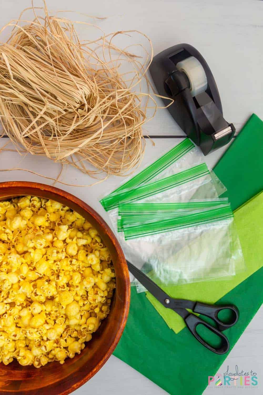 Supplies needed to make popcorn corn on the cob favor bags.