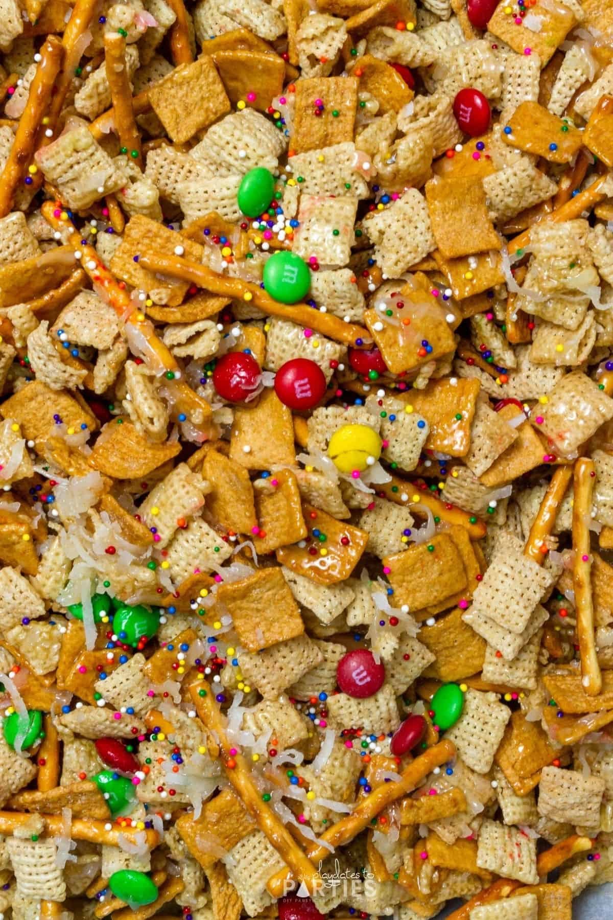 Overhead image of Chex Mix Christmas crack candy spread out on a pan.