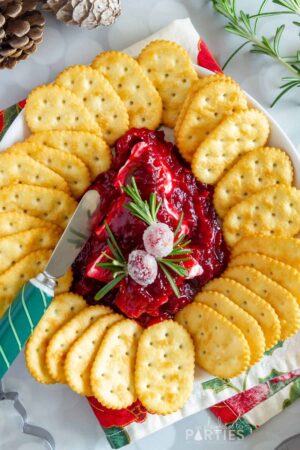 Overhead view of a red appetizer dip in the shape of a Christmas tree.