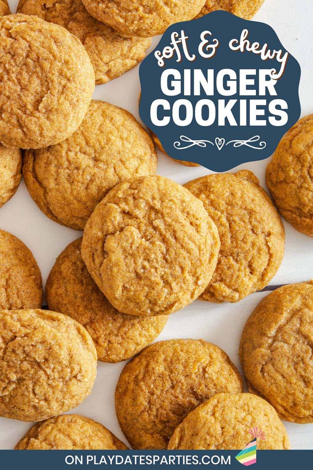 Overhead view of cookies piled on a table with text overlay soft and chewy ginger cookies.