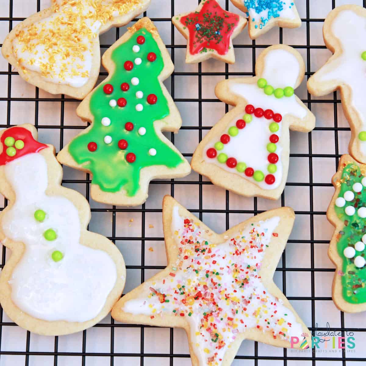 Sugar cookies for Christmas decorated with icing and sprinkles.