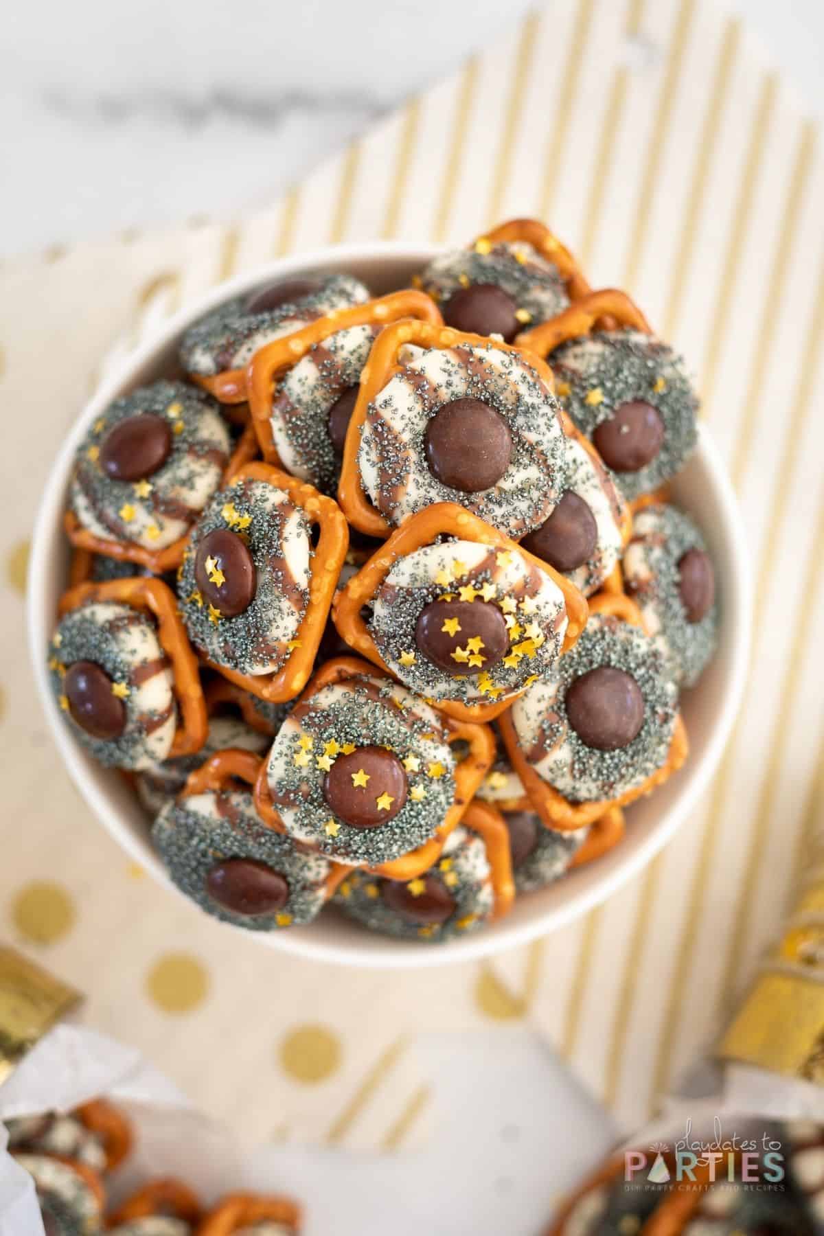 Overhead view of a bowl of chocolate covered pretzel bites.