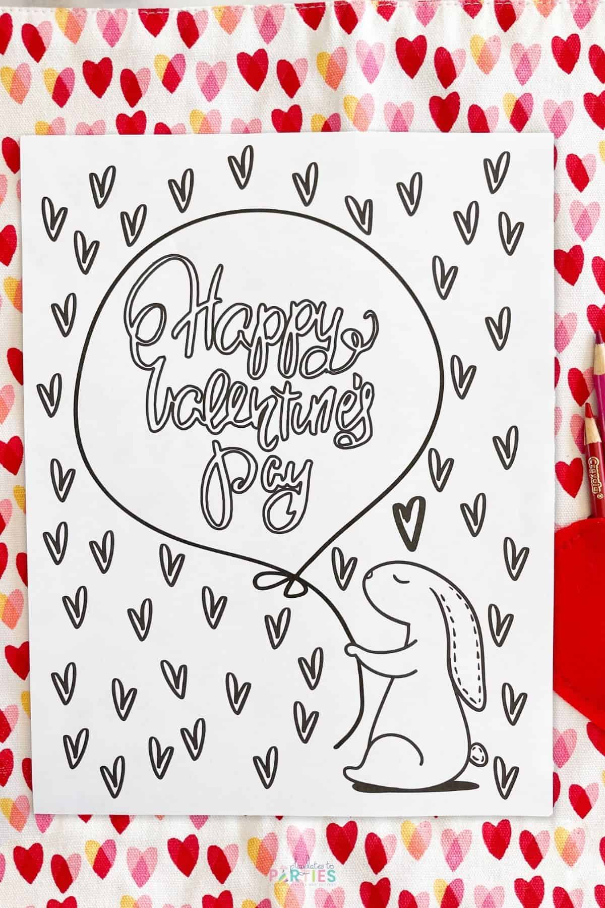 A blank coloring page that says Happy Valentine's Day on a balloon held by a bunny.