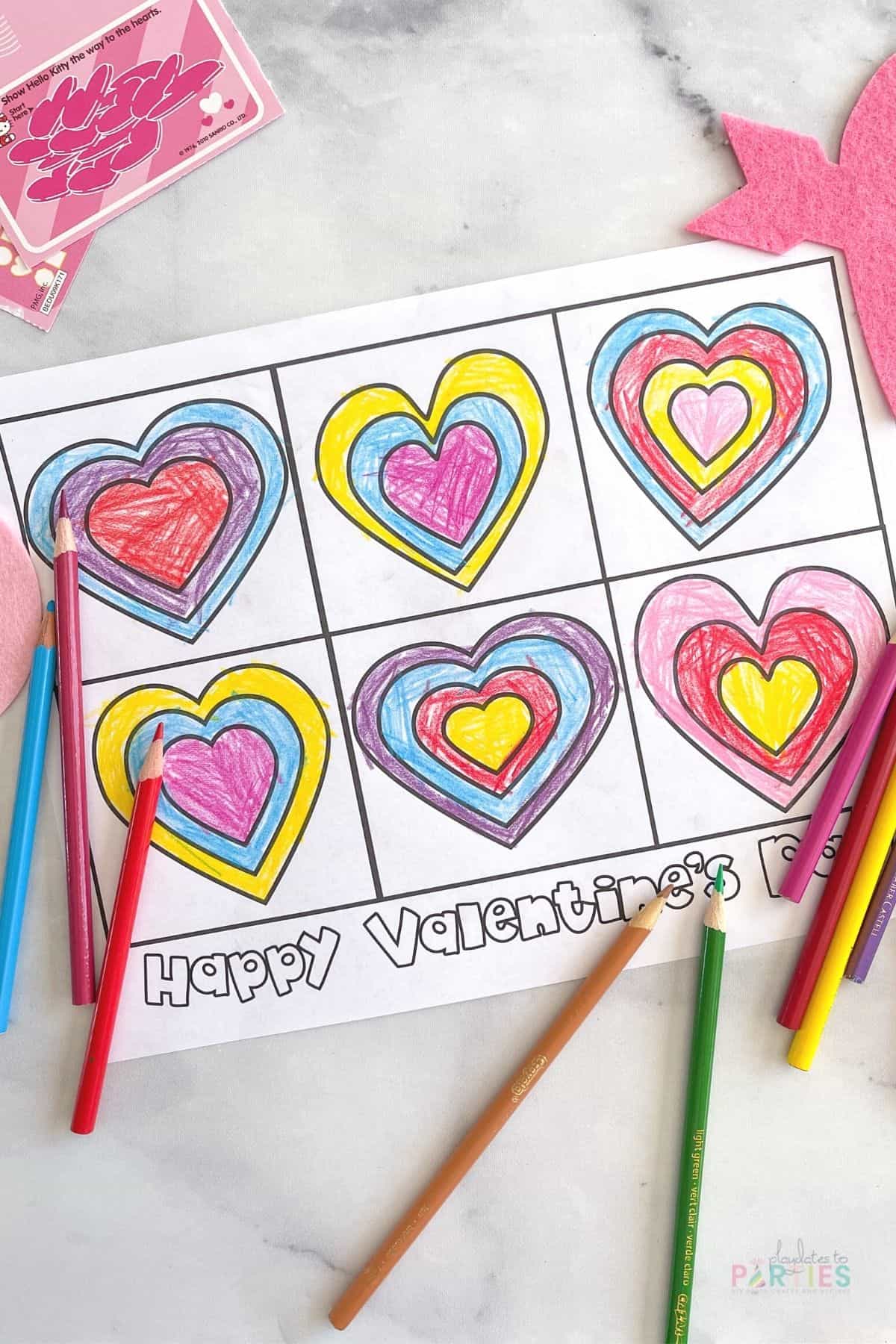 A free printable Valentine's Day coloring page with hearts surrounded by colored pencils.