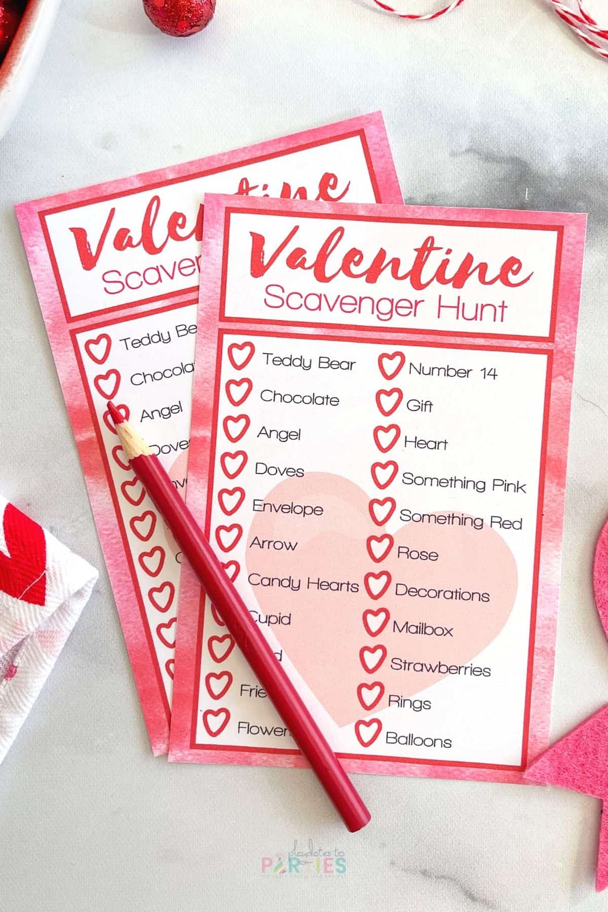Two Valentine's Day themed scavenger hunt cards with lists of items.