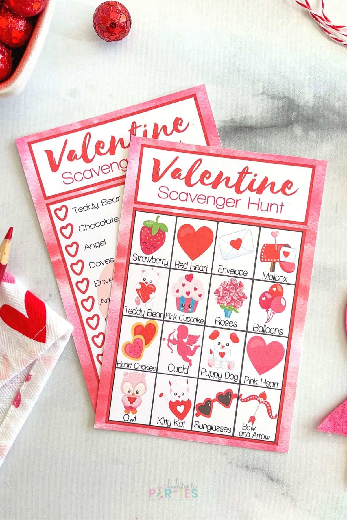 Two printable Valentine's Day games on a marble surface.
