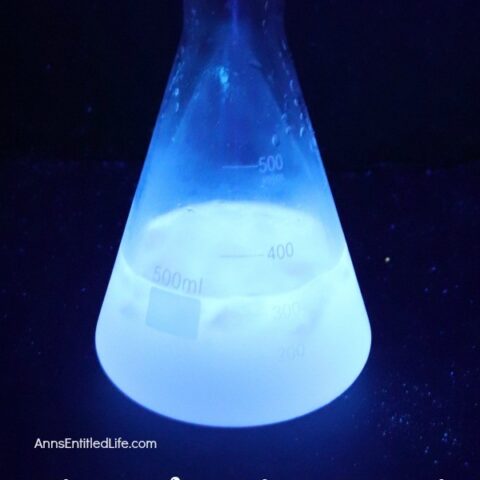 A cocktail glowing blue in a beaker.