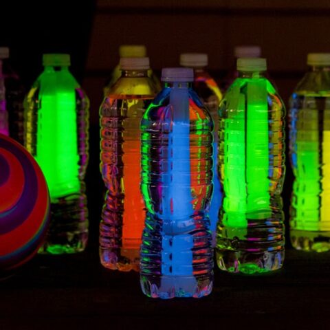 Water bottles with glow sticks for glow in the dark bowling.