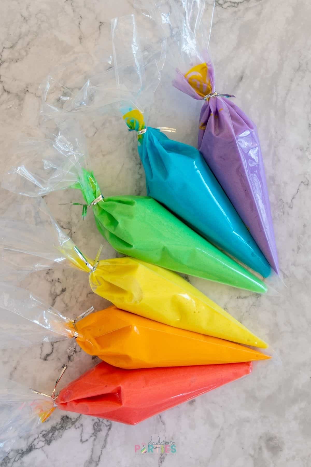 How to Make Rainbow Cupcakes Step 2 - Colored cake batter in piping bags.