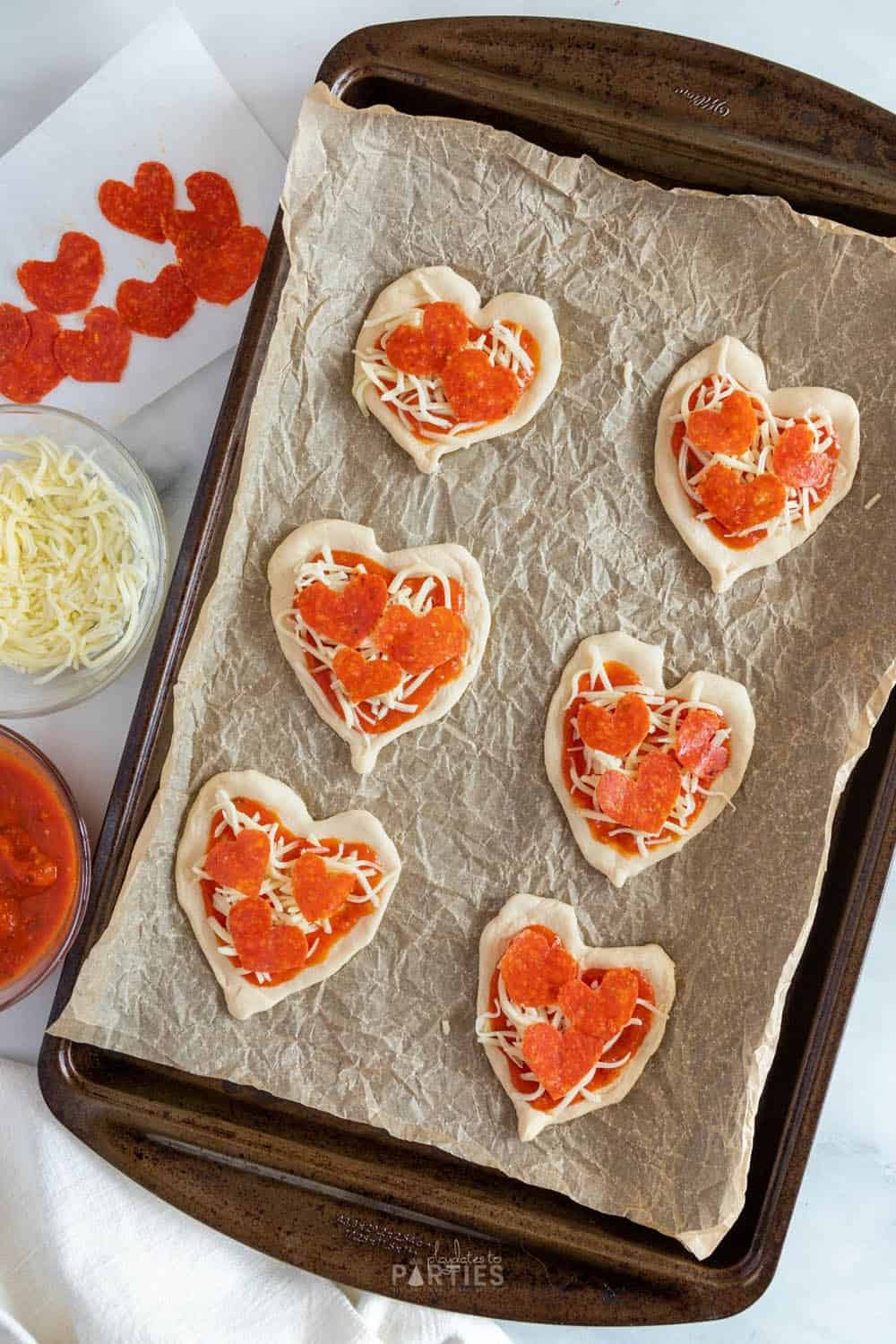 Mini Valentine heart pizzas ready to bake.