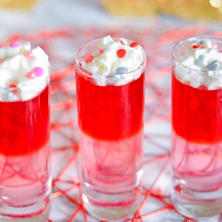 Layered Valentine's Day Jello shots on a red trivet.