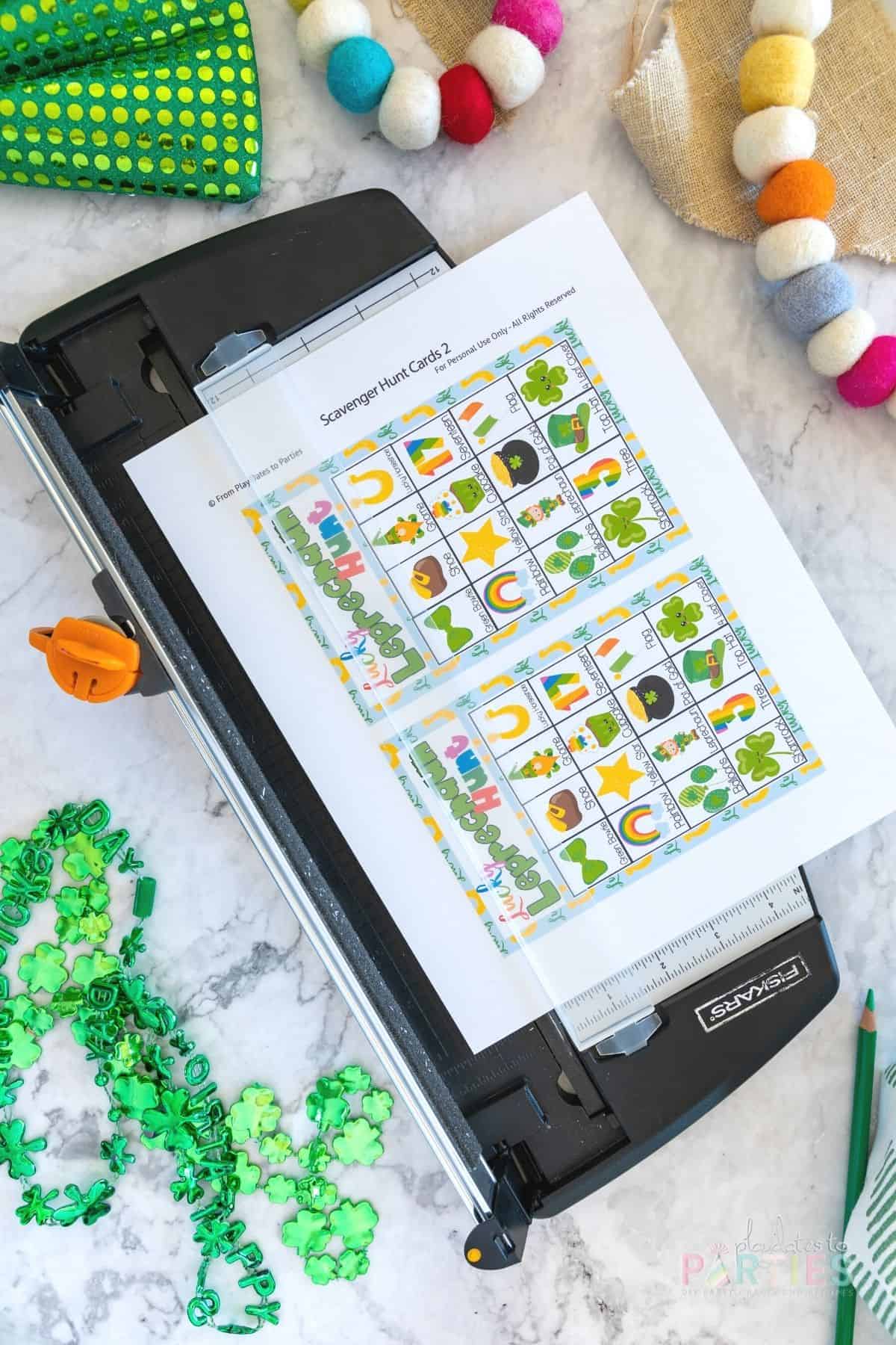 Printable St. Patrick's Day game in a paper trimmer for cutting.