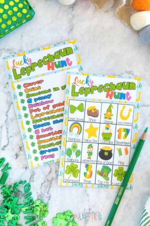Two versions of the free printable St. Patrick's Day scavenger hunt on a table.