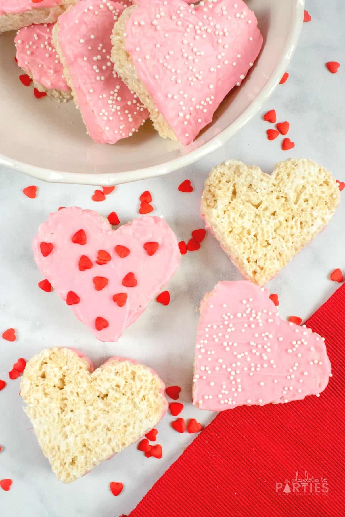 Valentine rice krispies with red heart sprinkles and white pearl sprinkles.