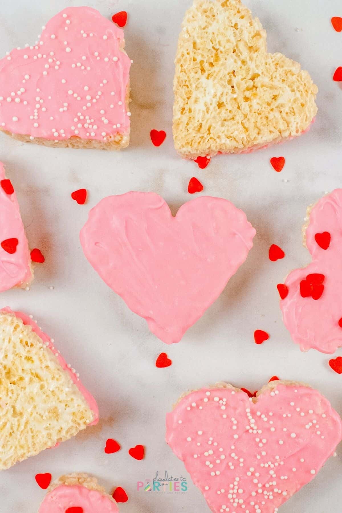 Valentine cereal treats decorated with pink chocolate and sprinkles.