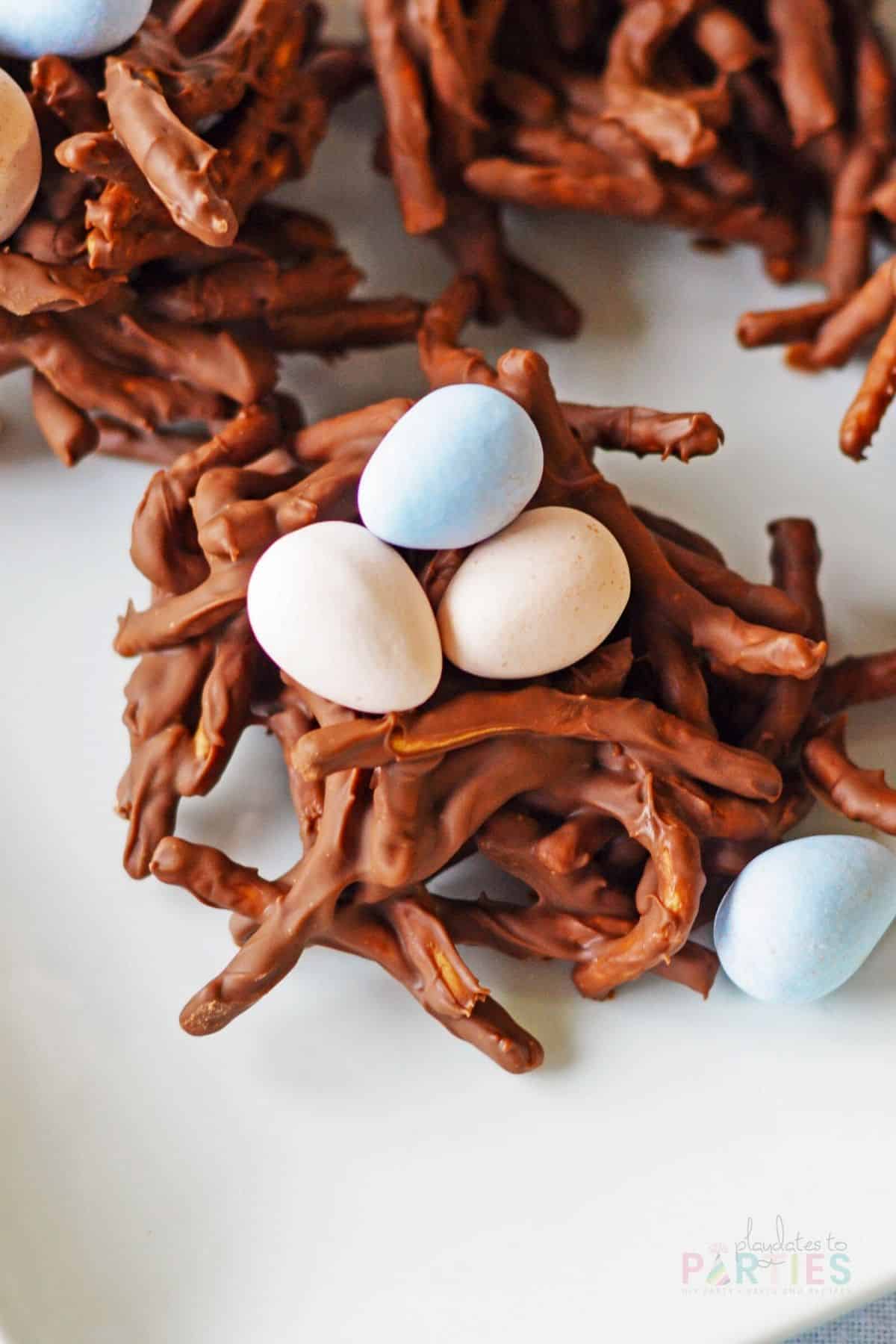 Chocolate chow mein noodle cookies with pink and blue eggs.