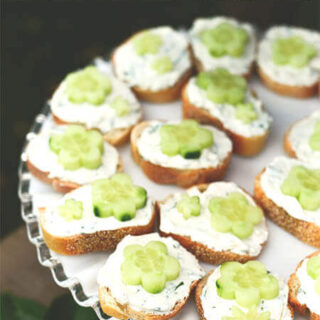 Open faced cucumber tea sandwiches with flower shaped cucumbers.