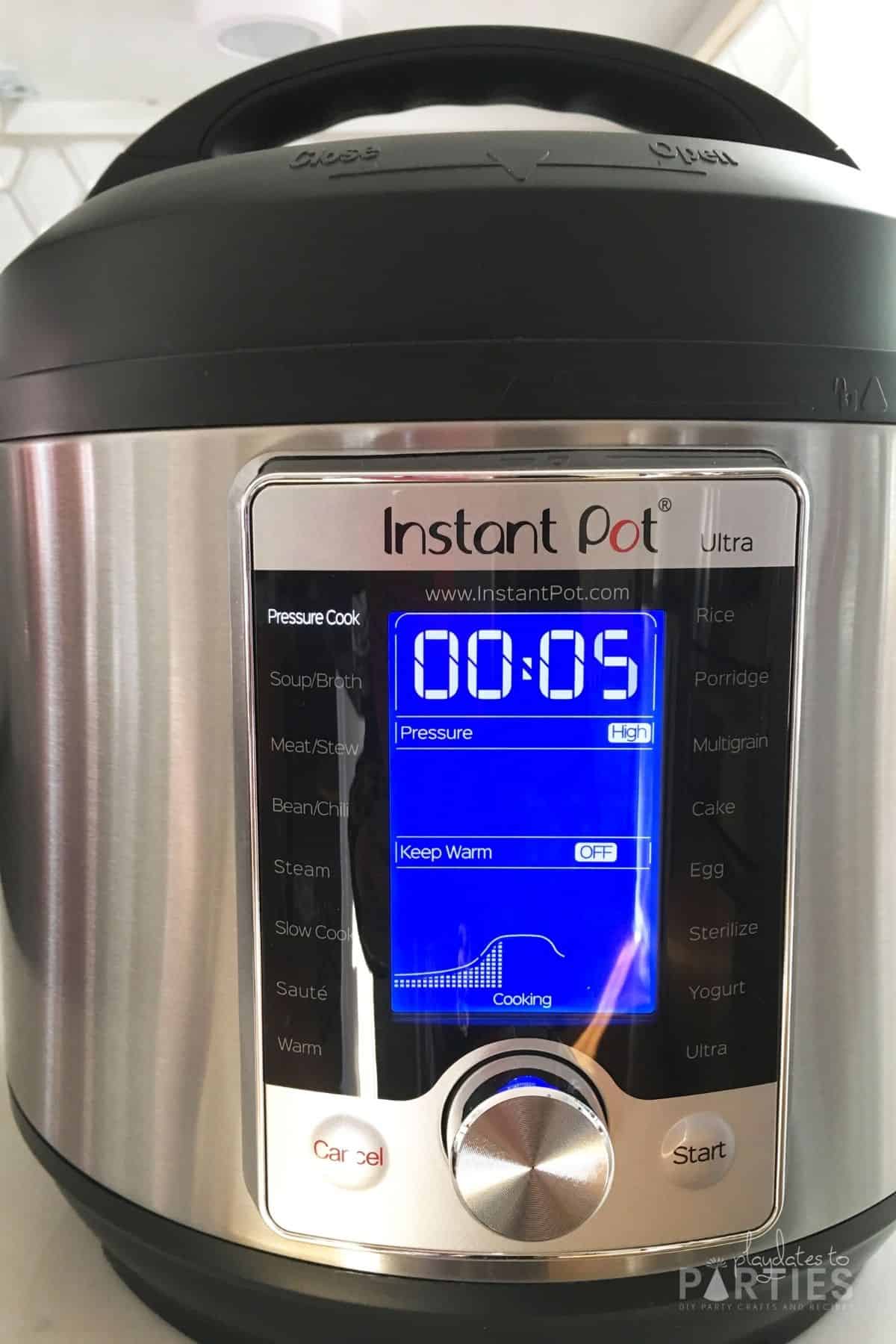 Instant Pot display set to 5 minutes high pressure.