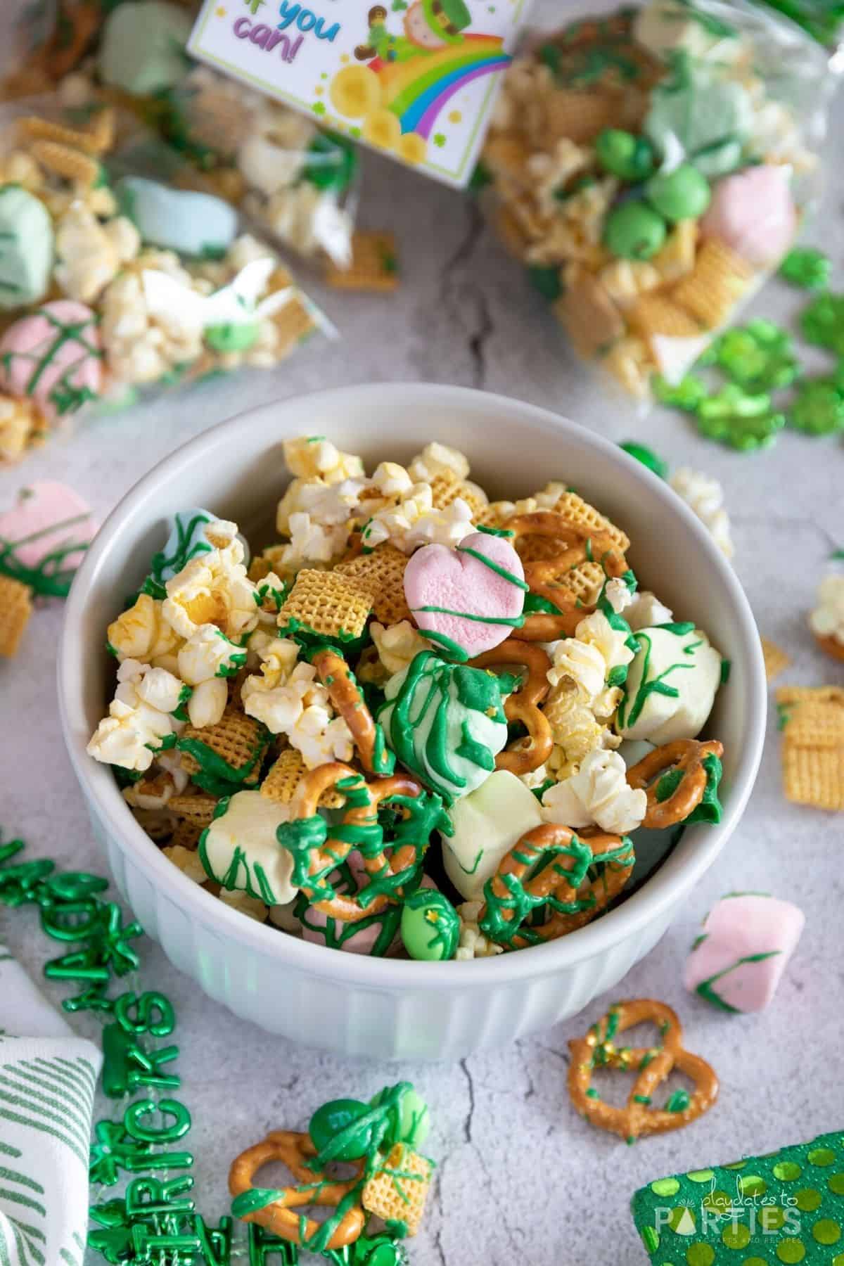 A bowl of St. Patrick's Day snack mix on a concrete surface.