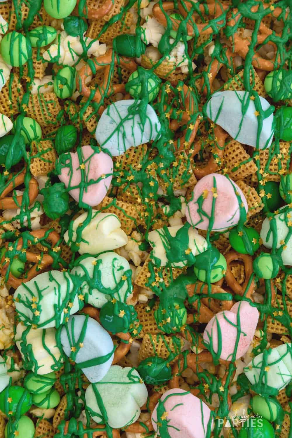 Close up of finished St. Patrick's Day snack mix with Chex, Lucky Charms marshmallows, and confetti stars.