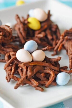 Chocolate chow mein noodle cookies with pink and blue eggs.