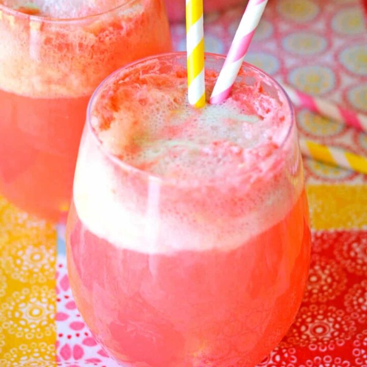 A wine glass filled with pink punch for a party.