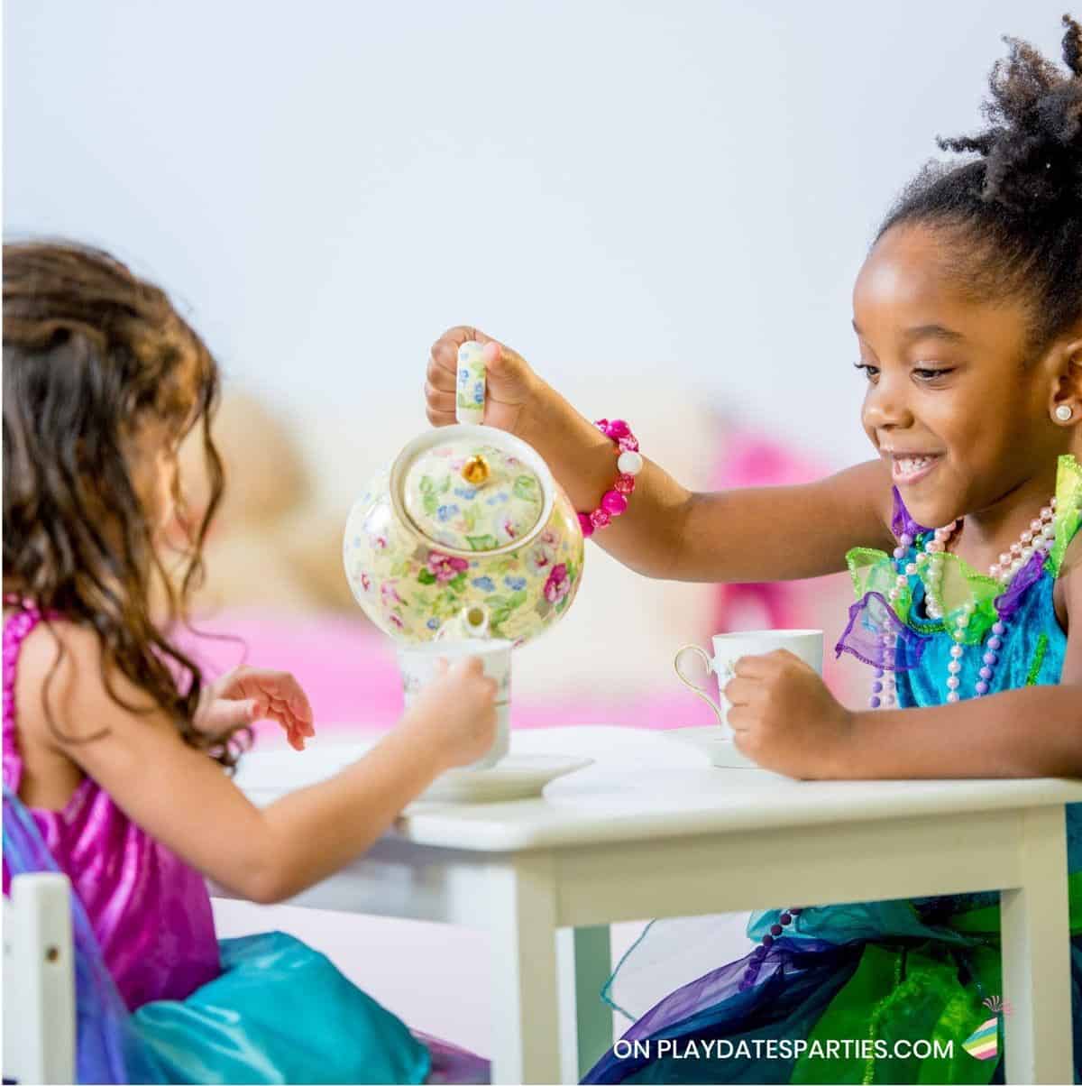 Two little girls having a tea party.