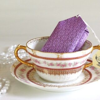 A teacup with a giant teabag shaped party favor inside.