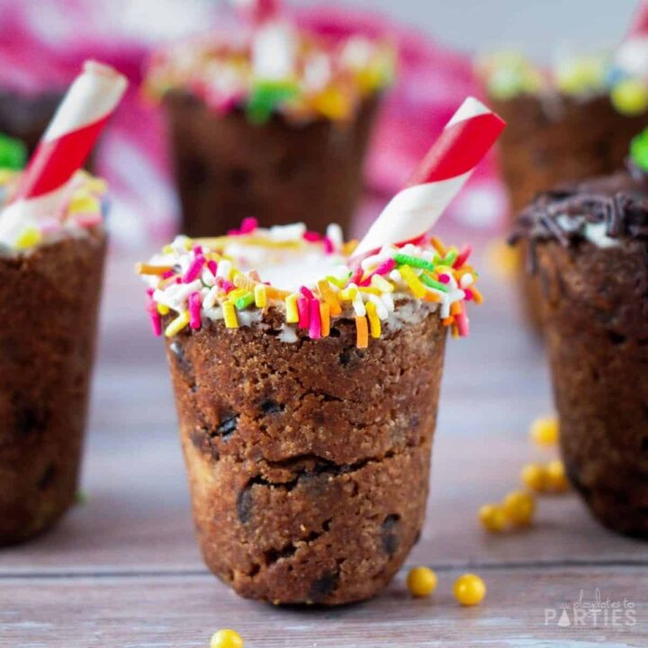 An edible cookie shooter made with chocolate chip cookie dough and decorated with sprinkles.