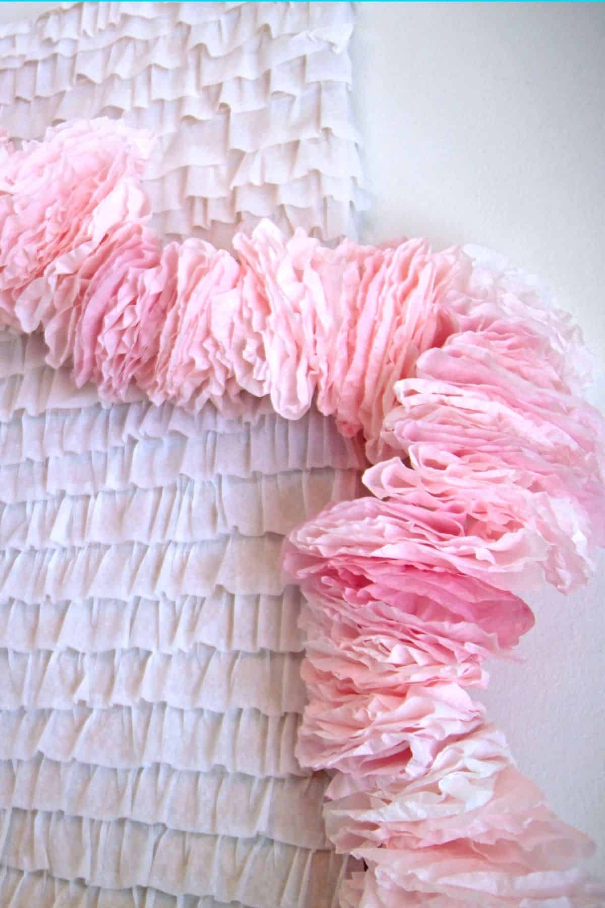 A ruffly pink garland made out of coffee filters.