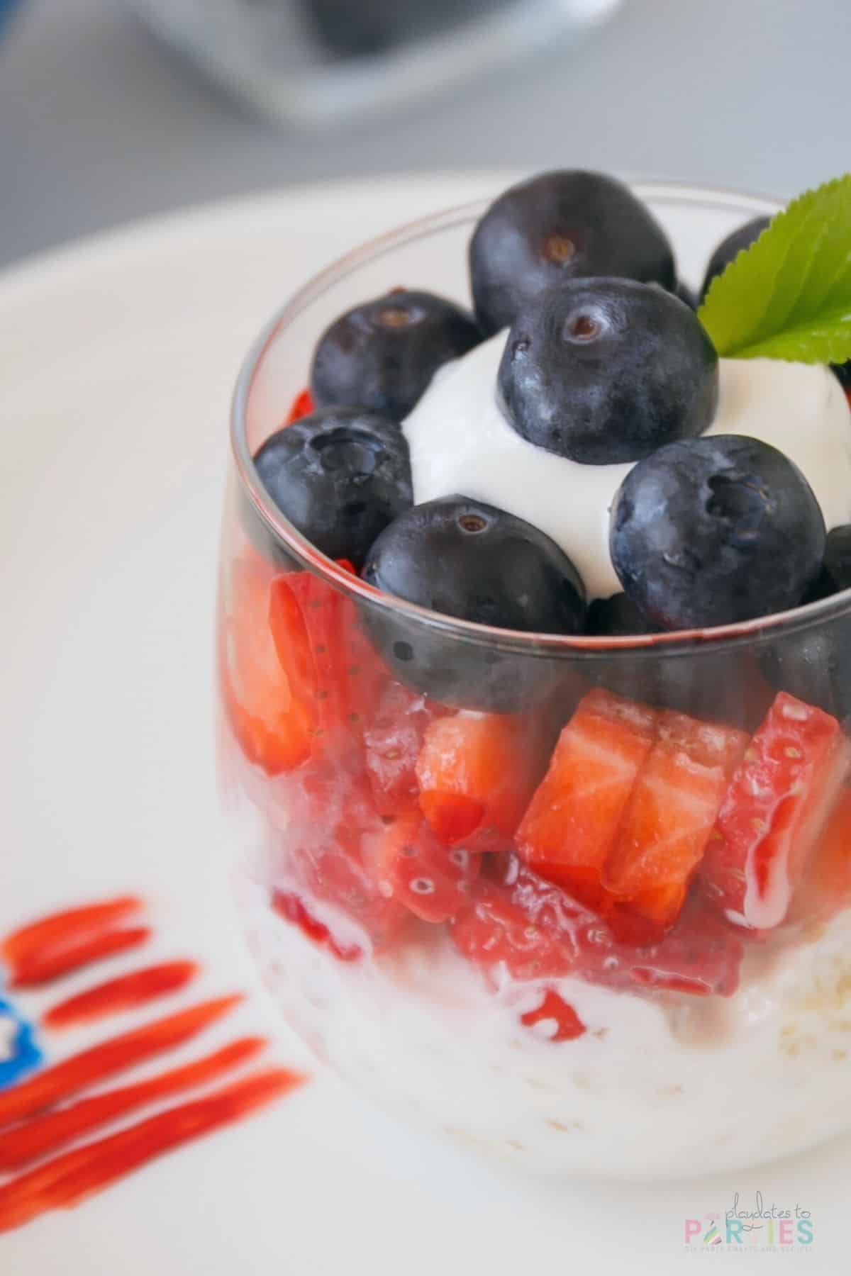 July 4th Yogurt Berry Parfait in a stemless wine glass.