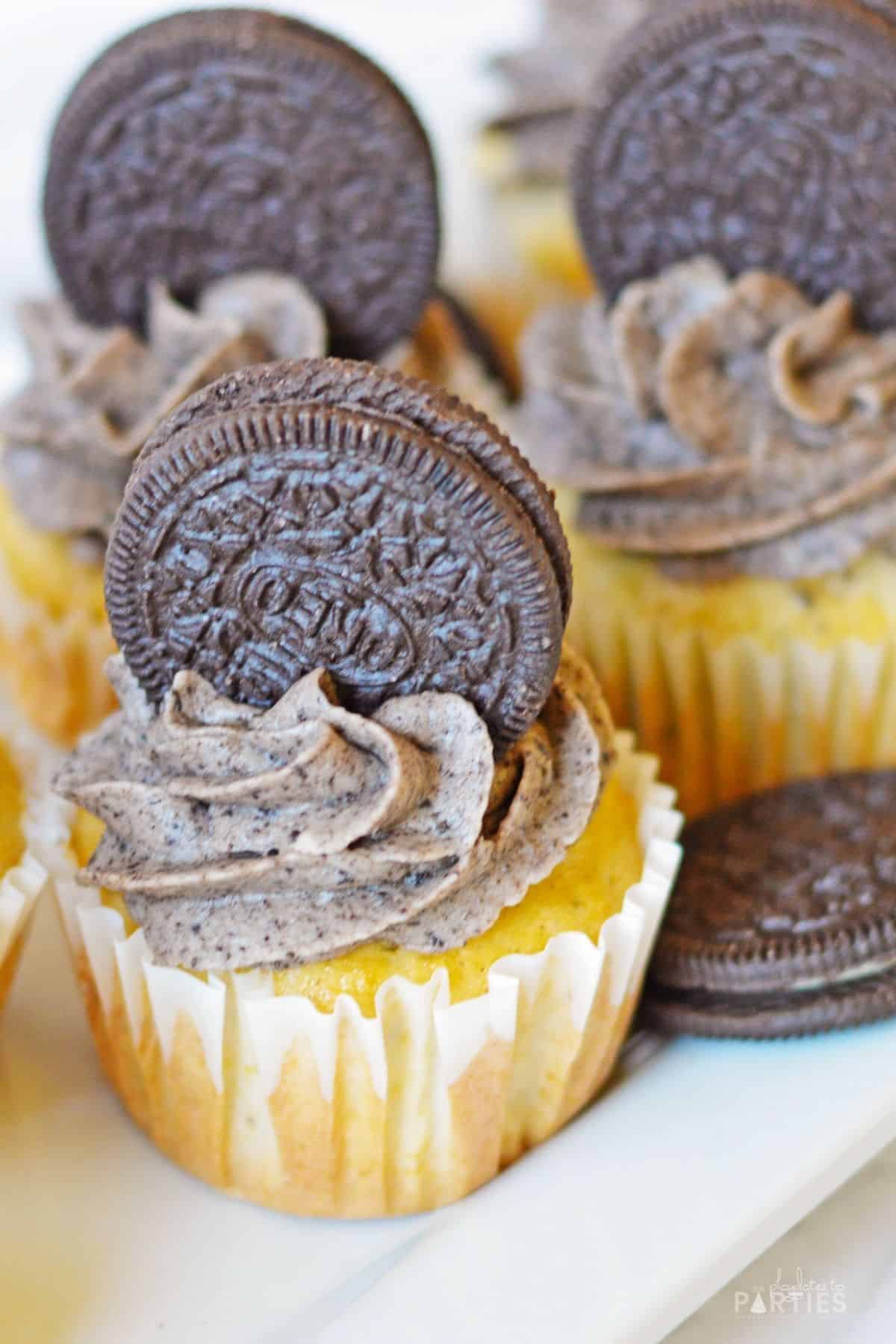 A plate filled with Oreo cupcakes and Oreo cookies.