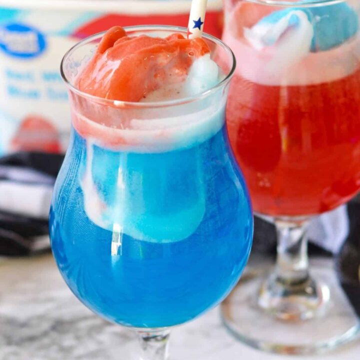Close up of a hurricane glass with red white and blue patriotic punch for July 4th.