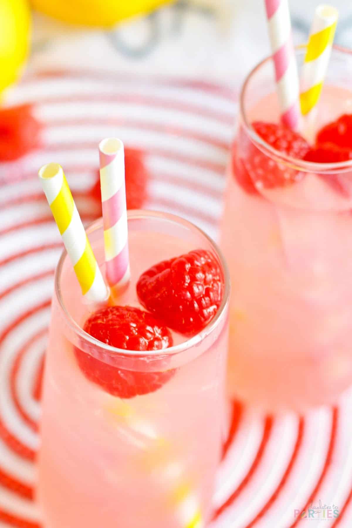 Overhead view of stemless champagne flutes filled with a pink lemonade cocktail.