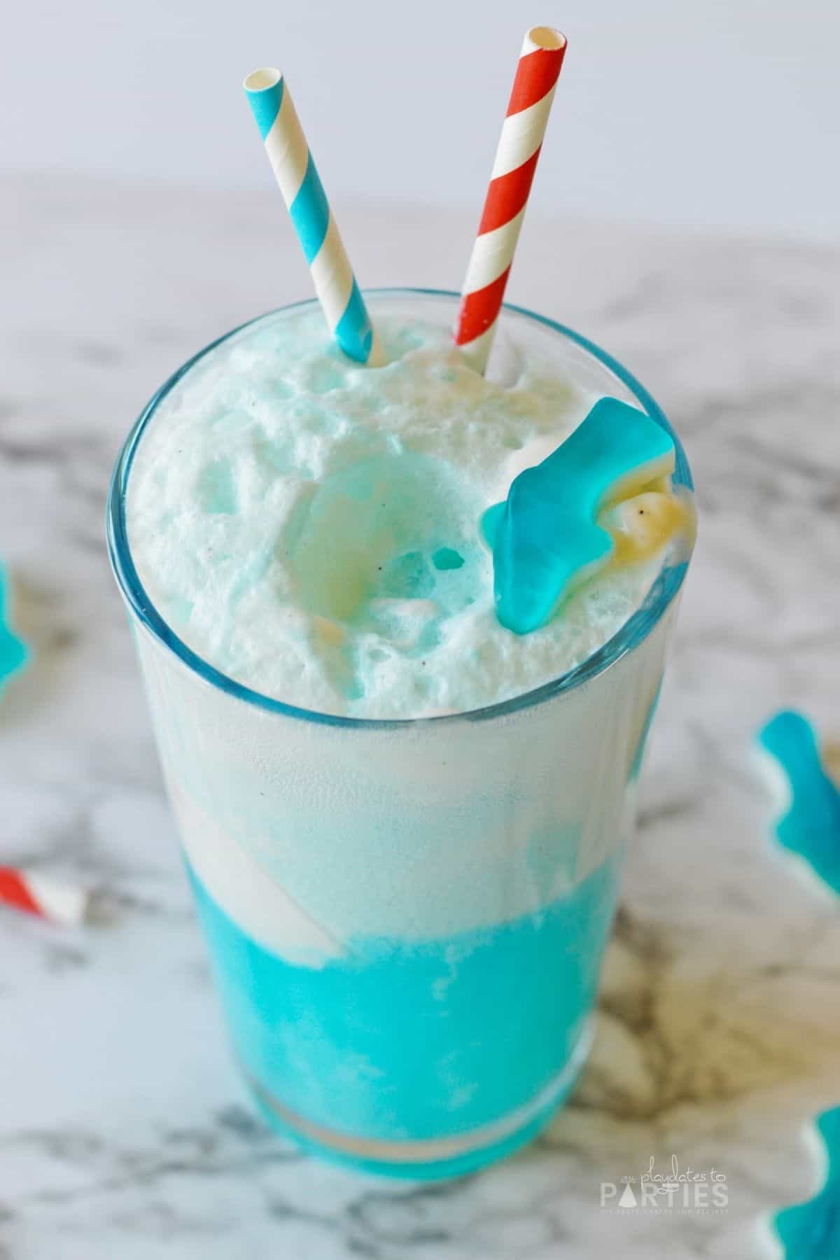 Foamy ocean water punch with a shark gummy on top.