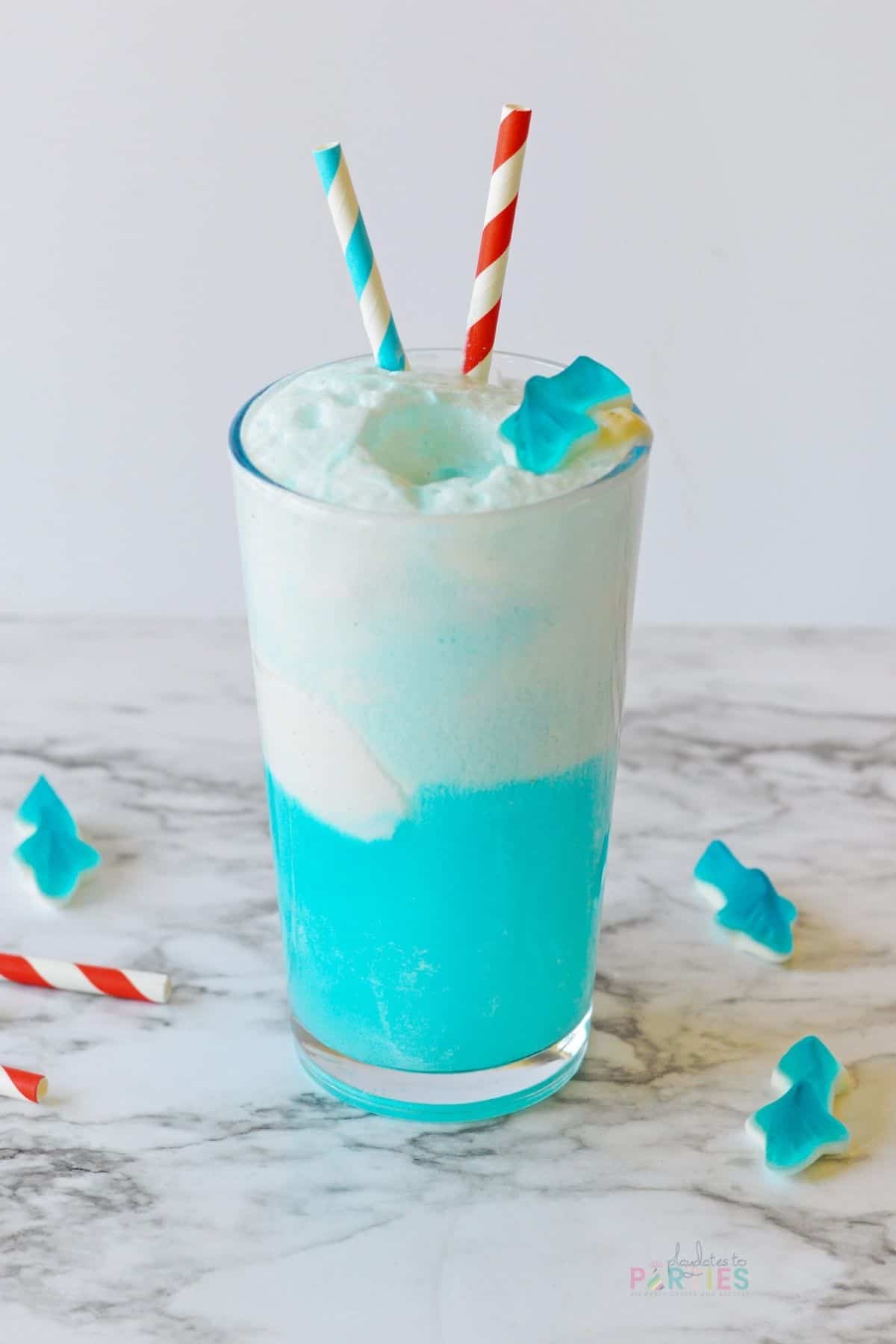 Blue shark attack punch with red and blue striped paper straws.