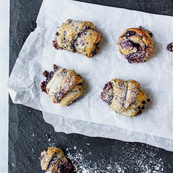 Blueberry crescent rolls on crumpled parchment paper.