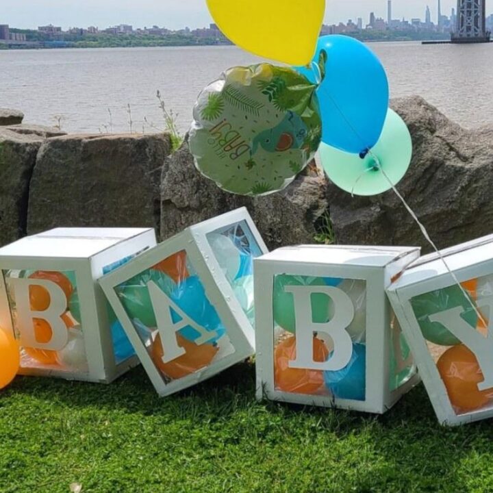 Large balloon filled blocks that spell Baby as baby shower decorations.